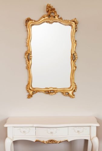 20542350 - golden mirror frame on the wall